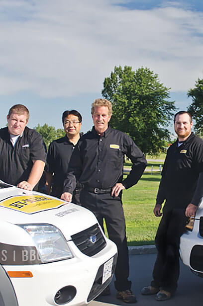 about the Hy-Mark team standing with branded company trucks